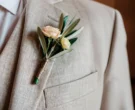 Groom's boutonniere with olive branch and roses | AI-generated image
